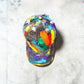Colorful tie-dye cap on a textured gray surface
