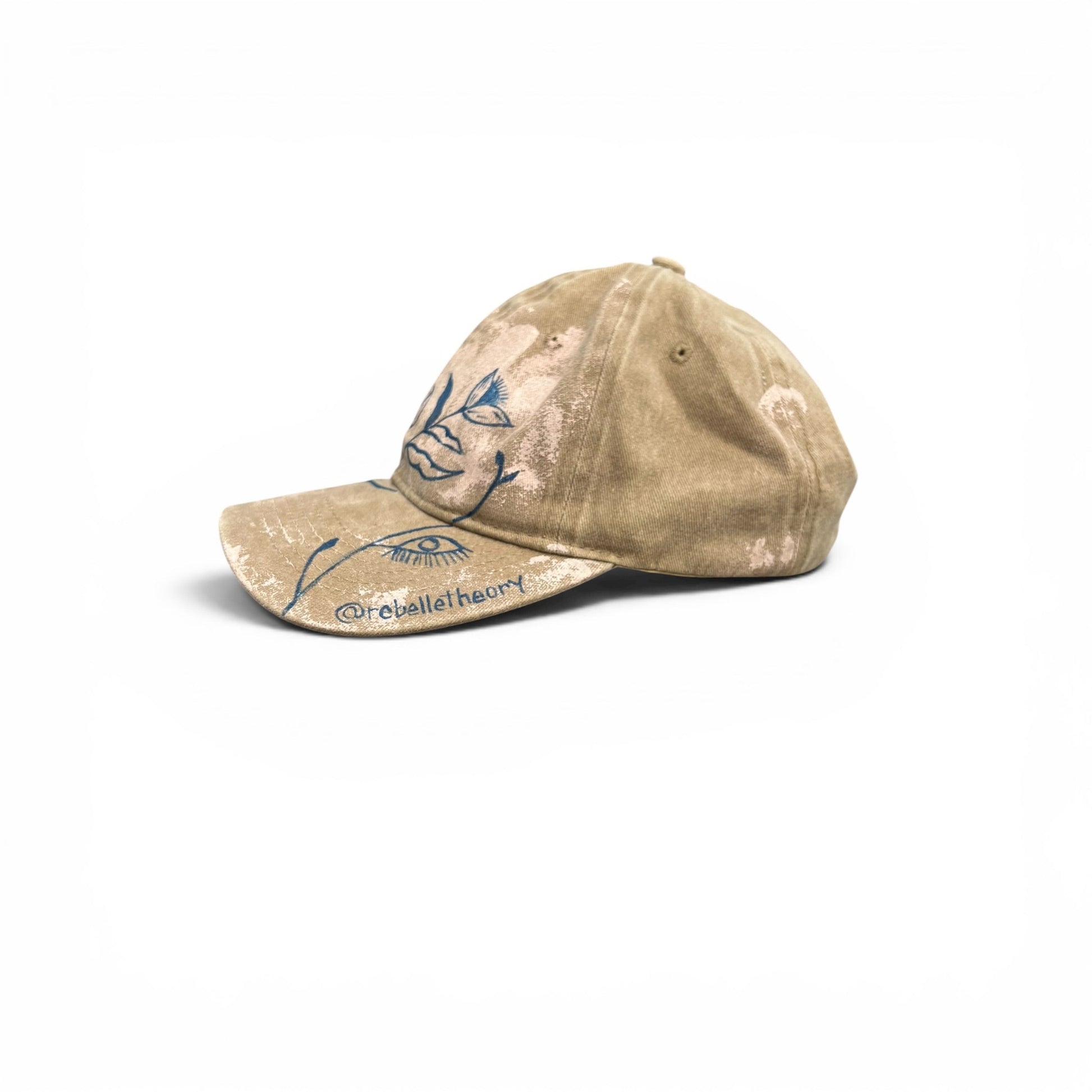 Beige cap with blue designs on a white background