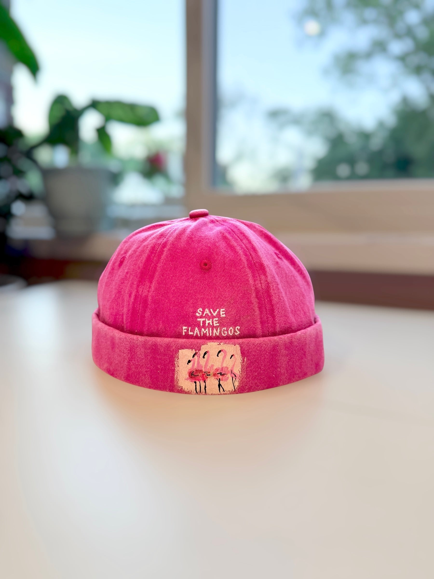 bright pink brimless cap featuring flamingos 
